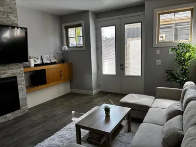 a living room with a couch and a tv at Nature Home Near Downtown and 17th Avenue in Calgary