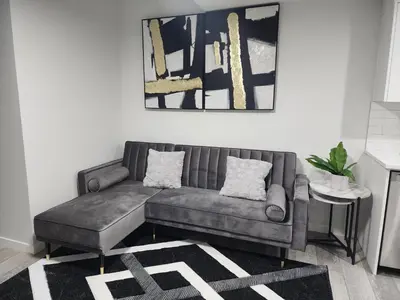 a living room with a couch and a table at Stylish furnished 2bedroom suite near YYC Airport in Calgary