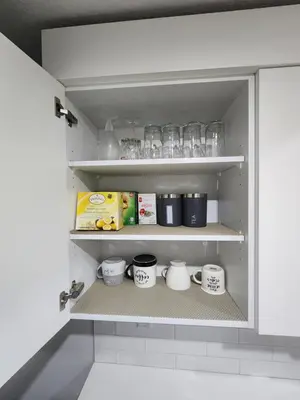 a cupboard with a bunch of mugs on it at Stylish furnished 2bedroom suite near YYC Airport in Calgary