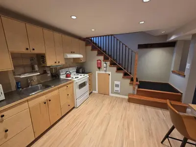 a kitchen with a sink and a stove top oven at NEW Midtown Rossland Studio Apartment in Rossland