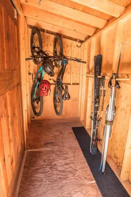 two bikes hanging from a wall in a cabin at NEW Midtown Rossland Studio Apartment in Rossland