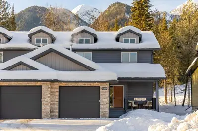 a house with snow on the roof at Four Bears Chalet by Fernie Central Reservations in Fernie