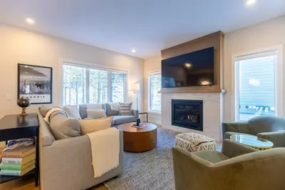a living room with a couch and a fireplace at Four Bears Chalet by Fernie Central Reservations in Fernie
