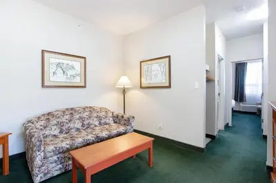 a living room with a couch and a table at Lakeview Inns & Suites - Okotoks in Okotoks