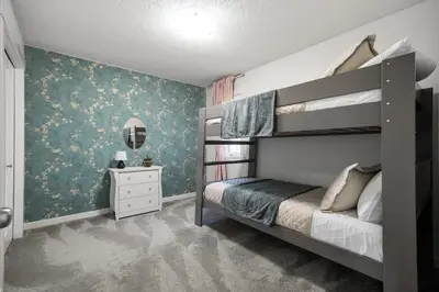 a bedroom with a bunk bed and a wall at The Copperleaf Luxury Retreat with Hot tub in Calgary