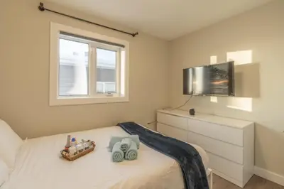a bedroom with a bed with a tv on it at Comfort Tenacity in Yellowknife