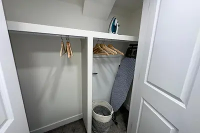 a walk in closet with a door and some shoes at Sleek Guest Retreat SW EDM BSMT Suite in Edmonton