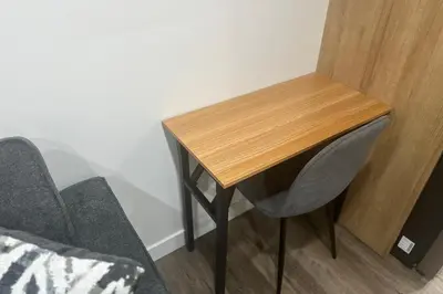a wooden table and two chairs in a room at Sleek Guest Retreat SW EDM BSMT Suite in Edmonton