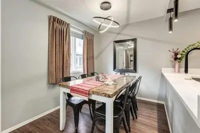 a kitchen and dining room with a table and chairs at Stunning 3BR Escape with Mountain Views in Canmore in Canmore
