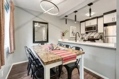 a kitchen and dining room with a table and chairs at Stunning 3BR Escape with Mountain Views in Canmore in Canmore
