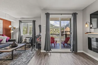 a living room with a couch and a table at Stylish 3BR Condo in DT Canmore in Canmore