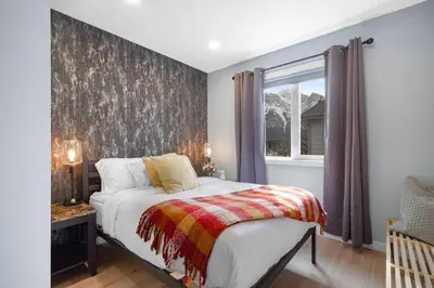a bedroom with a bed and a window at Great Rocky Mountain 3BR Condo in Canmore DT in Canmore