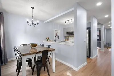 a kitchen and dining room with a table and chairs at Great Rocky Mountain 3BR Condo in Canmore DT in Canmore