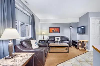 a living room with a couch and a table at Spacious 2BR unit near DT Canmore and Banff in Canmore