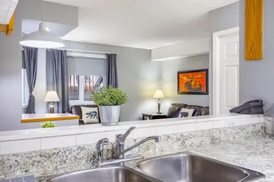 a kitchen with a sink and a living room at Spacious 2BR unit near DT Canmore and Banff in Canmore