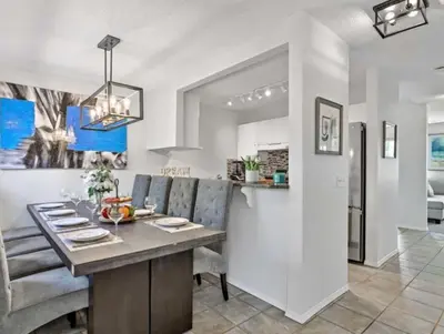a kitchen and dining room with a table and chairs at Rockies 3BR Townhome w Stunning Views Near DT in Canmore