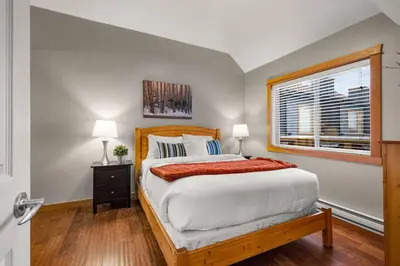 a bedroom with a large bed and a window at 3BR Luxury Top Floor Condo with Great views in Canmore