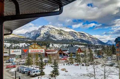 a view of a town with a snow covered mountain at Spacious 3 BR Condo with Gym and Hot tub in Canmore