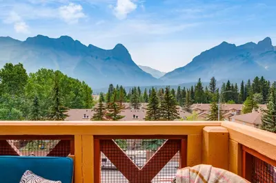 a balcony with a view of mountains at Spectacular 3BR Mountain Views with Hot Tub and Gym in Canmore