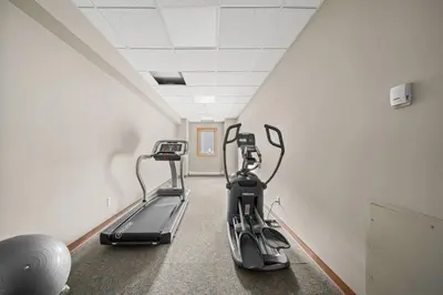 a gym with two exercise bikes in a room at Spectacular 3BR Mountain Views with Hot Tub and Gym in Canmore