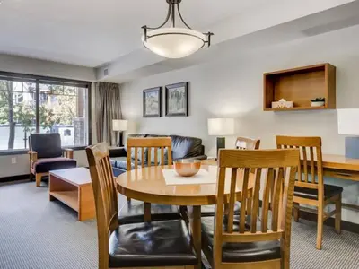 a dining room and living room with a table and chairs at Comfy 2BR Minutes from Downtown with Hot Tub in Dead Man's Flats