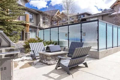 two chairs and a table with a grill on a patio at Comfy 2BR Minutes from Downtown with Hot Tub in Dead Man's Flats