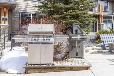 a grill sitting on a sidewalk in front of a house at Comfy 2BR Minutes from Downtown with Hot Tub in Dead Man's Flats