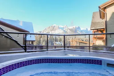 a balcony with a view of the mountains at 2BR Modern Luxe Condo with Hot Tub and Views in Canmore