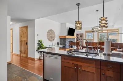 a kitchen with a sink and a counter at Mountain Views Lux 2BR Condo in Canmore with Hot Tub in Canmore