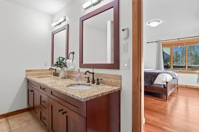 a bathroom with a sink and a mirror at Mountain Views Lux 2BR Condo in Canmore with Hot Tub in Canmore