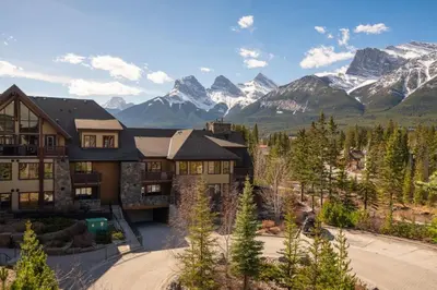 an aerial view of a house with mountains at Serene 3BR Rockies Stay with Hot Tub and Near DT in Canmore