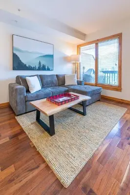 a living room with a couch and a coffee table at Serene 3BR Rockies Stay with Hot Tub and Near DT in Canmore