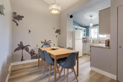 a kitchen and dining room with a wooden table and chairs at Casablanca - 3 BR Family & Game Haven in Calgary