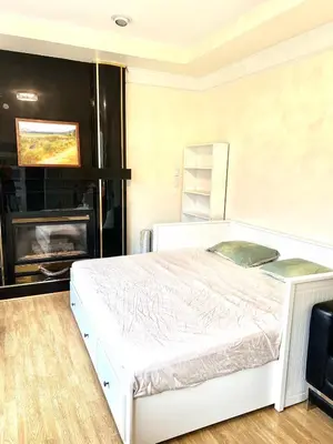 a bedroom with a white bed and a fireplace at Two Bedrooms One King Bed and One Double Bed in Richmond