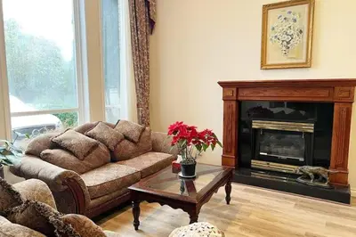 a living room with a couch and a fireplace at Two Bedrooms One King Bed and One Double Bed in Richmond