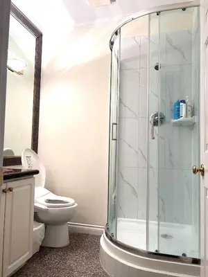 a bathroom with a toilet and a glass shower at Two Bedrooms One King Bed and One Double Bed in Richmond
