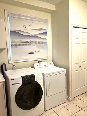 a laundry room with a washing machine and a painting at Two Bedrooms One King Bed and One Double Bed in Richmond