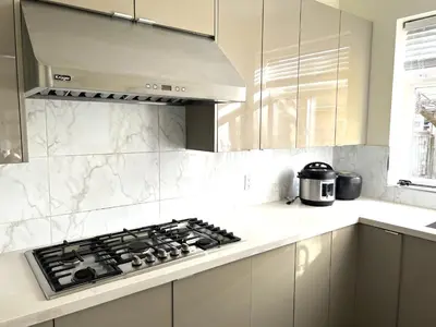 a kitchen with a stove top oven in a kitchen at Two Bedrooms One King Bed and One Double Bed in Richmond