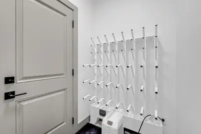 a bathroom with white towel racks next to a door at Western Star Chalet Ski in out and Amazing Mtn View in Big White