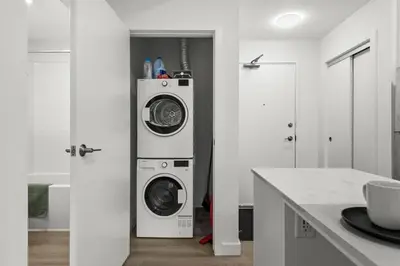 a kitchen with a washer and dryer in a room at GlobalStay Cozy 1 Bedroom Condo with Balcony Downtown Calgary in Calgary