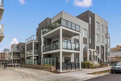 an apartment building with a parking lot at GlobalStay Cozy 1 Bedroom Condo with Balcony Downtown Calgary in Calgary
