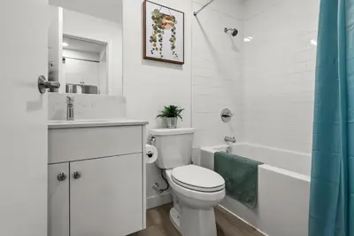 a white bathroom with a toilet and a sink and a tub at GlobalStay Cozy 1 Bedroom Condo with Balcony Downtown Calgary in Calgary