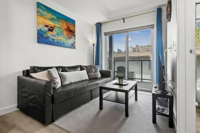 a living room with a black couch and a table at GlobalStay Cozy 1 Bedroom Condo with Balcony Downtown Calgary in Calgary