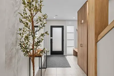 a hallway with a door and a plant at Sisters' Solstice Villa by WeekAway Vacations in Canmore