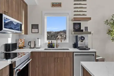a kitchen with a sink and a window at Sisters' Solstice Villa by WeekAway Vacations in Canmore