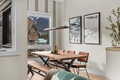 a dining room with a table and chairs and a window at Sisters' Solstice Villa by WeekAway Vacations in Canmore