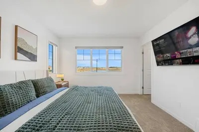 a bedroom with a large bed and a window at Luxury Family Retreat with Games, King Bed and Garage in Edmonton