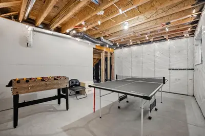 a ping pong table in a room with a ping pong ball at Single Detached Full House with Ping Pong King Bed and Garage in Edmonton