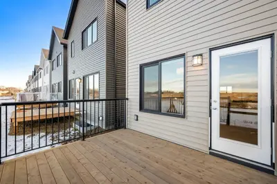 a house with a balcony with a door at Single Detached Full House with Ping Pong King Bed and Garage in Edmonton