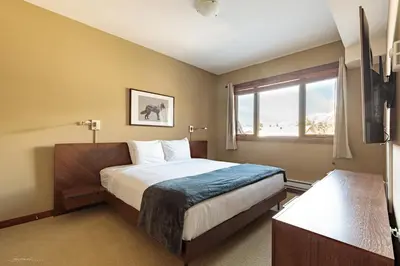 a hotel room with a bed and a window at El Paraiso - Luxury Downtown Penthouse in Canmore